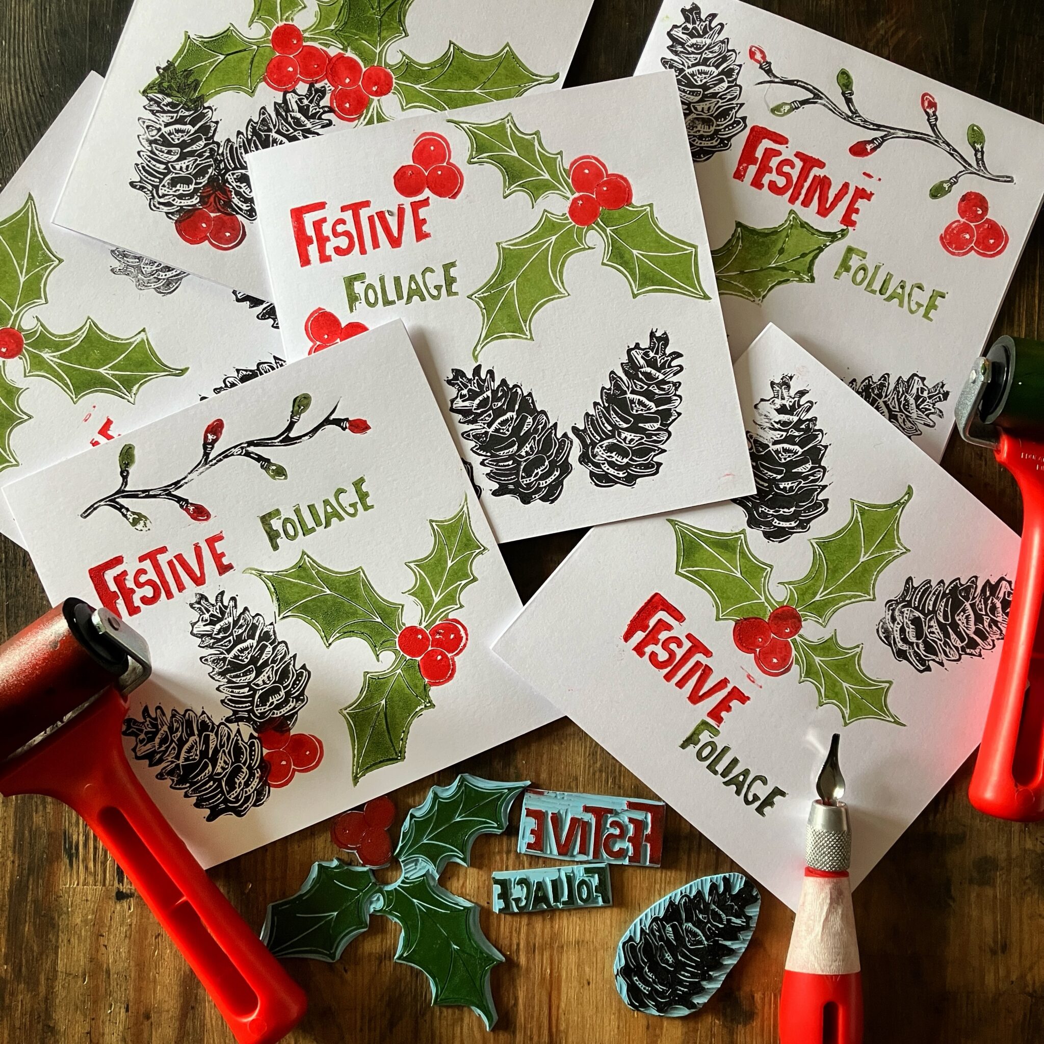 Some lino printed cards that read Festive Foliage